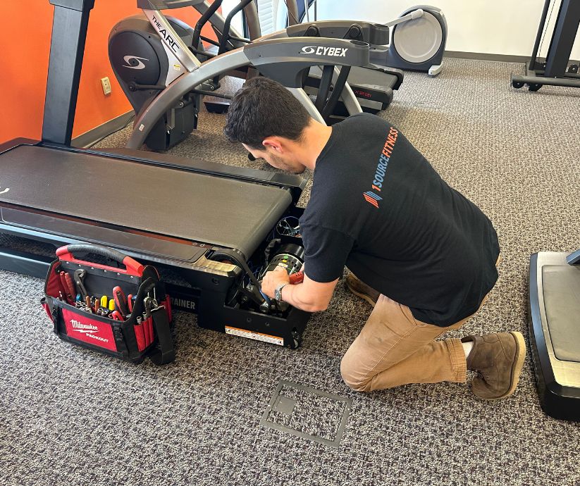 Man Fixing Treadmill